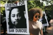  ?? JOHN MINCHILLO — THE ASSOCIATED PRESS FILE ?? FILE- In this file photo, protesters holds signs as they gather for a demonstrat­ion on the University of Cincinnati campus demanding that a white former police officer be tried a third time in the fatal shooting of an unarmed black motorist in...