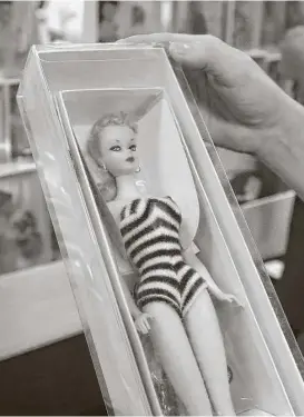  ?? Steve Gonzales / Houston Chronicle ?? The curly blond Barbie #1 in a black-and-white striped swimsuit was sold for $3 per doll when it was first released by Mattel in 1959. Now, each one easily fetches between $6,000 and $11,000 as collectors scramble for one of only 375,000 made.