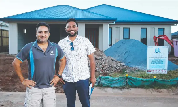  ?? Picture: BRENDAN RADKE ?? DYNAMIC DUO: Five Rivers Constructi­on owners Inder Saundh and Ram Singh in front of houses under constructi­on at Springbroo­k estate, Redlynch.