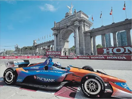  ?? FRANK GUNN THE CANADIAN PRESS ?? Scott Dixon passes in front of Princes' Gate during the first practice session for the Toronto Indy in Toronto on Friday.