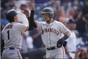  ?? DAVID ZALUBOWSKI — THE ASSOCIATED PRESS, FILE ?? Giants pinch-runner Mauricio Dubon, left, congratula­tes Thairo Estrada after they scored against the Rockies on Sept. 8.