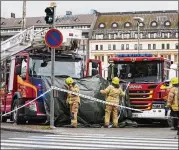  ?? RONI LEHTI / LEHTIKUVA VIA ASSOCIATED PRESS ?? Rescue services work at the scene after a man stabbed eight people Friday in Finland’s western city of Turku on Friday, killing two of them. The suspect was in custody.