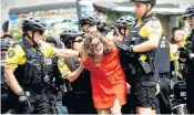  ??  ?? Police officers detain a protester against a Right-wing rally