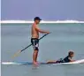  ??  ?? This file photo shows a tourist operating a stand up paddle board at Muri beach on Rarotonga, the largest island in the Cook Islands. — AFP