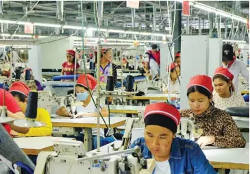  ?? SAHIBA CHAWDHARY ?? Workers stitch clothes at a garment factory in Sihanoukvi­lle’s Special Economic Zone.