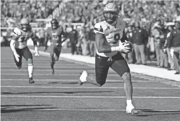  ?? JEFF SWINGER/USA TODAY SPORTS ?? Arizona State tight end Jay Jay Wilson (9) runs back an intercepti­on for a touchdown in the fourth quarter against Utah in Salt Lake City on Saturday.