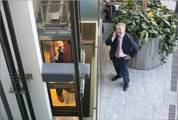  ??  ?? Patrick Browne’s winning picture of Cllr George Lawlor, trapped in a lift, speaking on the phone with a clearly amused Deputy Brendan Howlin during the Labour Party conference in Clayton White’s Hotel, Wexford, last year.