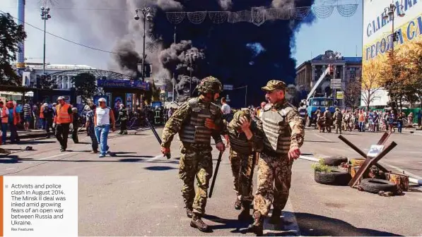  ?? Rex Features ?? Activists and police clash in August 2014. The Minsk II deal was inked amid growing fears of an open war between Russia and Ukraine.