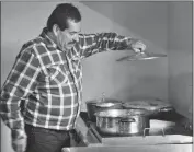  ?? PHOTO BY CESAR NEYOY/BAJO EL SOL ?? ASCENCION SERNA INSPECTS THE FOOD that will be served that day to migrants at the Don Chon Migrant Shelter in San Luis Rio Colorado, Son.