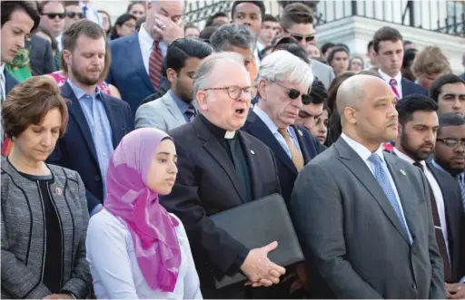  ?? AP FILE PHOTO ?? The Rev. Patrick Conroy ( center), chaplain of the House of Representa­tives, on the steps of the Capitol in Washington in 2016.