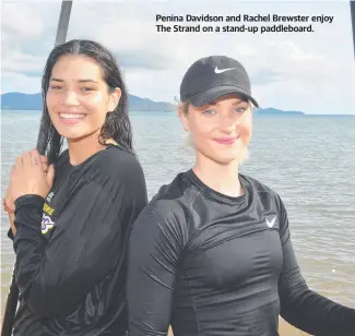  ??  ?? Penina Davidson and Rachel Brewster enjoy The Strand on a stand-up paddleboar­d.