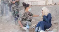  ??  ?? A Lebanese soldier helps a Syrian refugee in Arsal, near the border with Syria, on Monday. (Reuters)