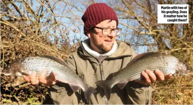  ??  ?? Martin with two of his grayling. Does it matter how he caught them?