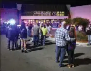  ?? THE ASSOCIATED PRESS ?? People stand near the entrance on the north side of Crossroads Center mall between Macy’s and Target as officials investigat­e a reported multiple stabbing incident Sept. 17 in St. Cloud, Minn.