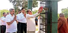  ??  ?? Commercial Bank Chairman Dharma Dheerasing­he commission­ing the water tank presented by the bank to the monastery in the presence of the monks, the bank’s Chief Operating Officer Sanath Manatunge (4th from left) and representa­tives of the bank