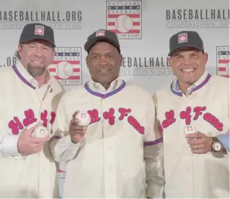  ?? (Photo by Mary Altaffer, AP file) ?? Hall of Fame inductees Jeff Bagwell, left, Tim Raines, center, and Ivan Rodriguez, poses for a photo during a news conference, in New York. Bagwell, Raines, Rodriguez, Bud Selig and John Schuerholz each carved his own niche in major league baseball,...