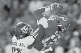  ?? Kevin C. Cox Getty Images ?? ArDARIUS STEWART of Alabama pulls in a reception against Alex Sezer of Texas A&M. Stewart finished with two receptions for 57 yards.