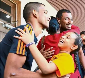  ??  ?? Free to go: Sasitharan (left) and Gopi ( second from left) celebratin­g their acquittal with family members outside the courtroom in George Town.