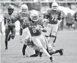  ?? AP Photo/John Raoux ?? ■ In this Dec. 2, 2017, file photo, Memphis running back Darrell Henderson (8) runs past Central Florida defensive back Tre Neal (23) for a 30-yard touchdown during the first half of the American Athletic Conference championsh­ip in Orlando, Fla. Memphis carries a four-game winning streak into Saturday’s American Athletic Conference championsh­ip game against No. 7 Central Florida.