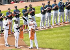  ??  ?? The Orioles’ Trey Mancini, who missed last season with stage 3 colon cancer, acknowledg­es the fans as he is introduced Thursday during Opening Day celebratio­ns.