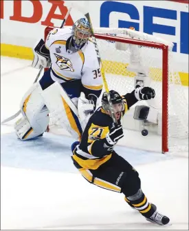  ?? The Associated Press ?? Pittsburgh Penguin Evgeni Malkin celebrates after scoring against Nashville Predators goalie Pekka Rinne during the third period of Game 2 of the NHL Stanley Cup Final, Wednesday in Pittsburgh. Pittsburgh won 4-1 and leads the series 2-0.