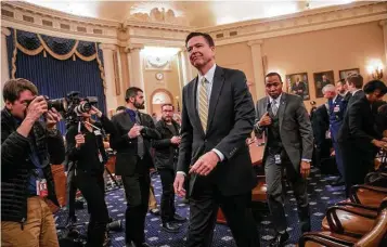  ?? J. Scott Applewhite / Associated Press ?? FBI Director James Comey takes a break during the grueling hours of testifying Monday on Capitol Hill.