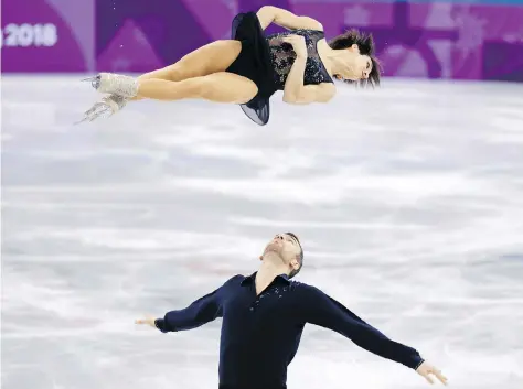 ?? PHOTOS: LEAH HENNEL ?? Look waaaay up: Canada’s Meagan Duhamel and Eric Radford placed second in the pairs short program Friday, with a score of 76.57 points. “Anything between 75 and 80 is a really high score for us, so we’re happy with that,” Duhamel said.