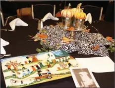  ?? Janice McIntyre/News-Times ?? Decoration­s: A tray with artwork by acclaimed folk artist Clementine Hunter accentuate­s the fall motif that served as the centerpiec­e of each table during the Traveling Friends’ November meeting in the El Dorado Conference Center. Hunter was a...