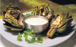  ?? CARLINE JEAN/STAFF PHOTOGRAPH­ER ?? Head chef Louis Najarro shared what one reader calls the “most delicious from Madisons New York Grill & Bar in Boca Raton. grilled artichokes”