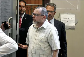  ??  ?? Below left, Greg Priore examines a book in the library’s Oliver Room in 1999. Below, Schulman after his preliminar­y arraignmen­t at Pittsburgh Municipal Court in July 2018.