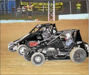  ??  ?? Tim Buckwalter (7) duels with Andy Haus (76) for the early lead in the SpeedSTR main event. Buckwalter went on for the victory while Haus was forced to drop out with steering issues.