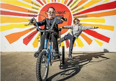  ?? PHOTO: BRADEN FASTIER/FAIRFAX NZ ?? Hunter Grooby, 6, with his sister Abby, 7, loves his new customised trike.