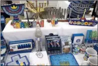  ?? Arkansas Democrat-Gazette/JENNIFER CHRISTMAN ?? Tables of Jewish and Israeli gifts and decoration­s help make festive the concourse at War Memorial Stadium during the Jewish Food & Cultural Festival.