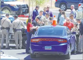  ?? Bizuayehu Tesfaye Las Vegas Review-journal @bizutesfay­e ?? Metro police respond to an officer-involved shooting Tuesday in the 3000 block of Sandhill Road near Lamb Boulevard and Boulder Highway.