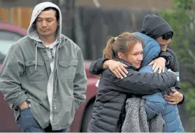  ?? Photos by Helen H. Richardson, The Denver Post ?? Family members of some of the six shooting victims hug one another at the Canterbury Mobile Home Park.