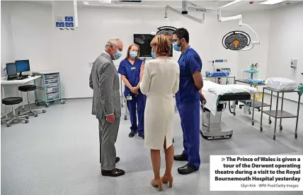  ?? Glyn Kirk - WPA Pool/Getty Images ?? > The Prince of Wales is given a tour of the Derwent operating theatre during a visit to the Royal Bournemout­h Hospital yesterday