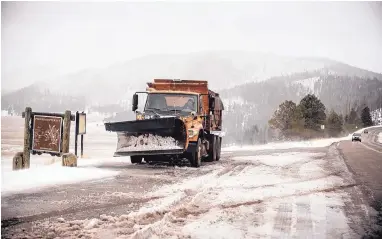  ?? ROBERTO E. ROSALES/JOURNAL ?? A snowplow works along N.M. 4 in the Jemez Mountains near the Valles Caldera National Preserve on Thursday afternoon. A winter storm was expected to drop up to 30 inches of snow in the northern mountains by today.