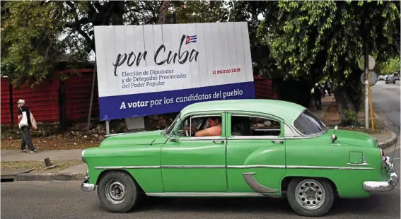  ?? PHOTO: ALEJANDRO ERNESTO/EPA ?? END OF ERA: A classic car in Havana drives past a sign announcing Cuba’s election, after almost 60 years under the rule of the Castro brothers.