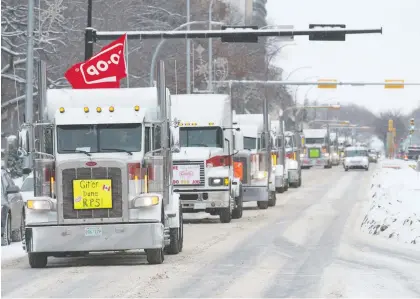  ?? BRANDON HARDER ?? A convoy of some 80 big rigs moves along Victoria Avenue toward downtown Regina on Thursday with horns blaring.