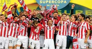  ?? (AFP) ?? Athletic Bilbao's players celebrate after winning the Spanish Super Cup final against Barcelona at La Cartuja stadium in Seville, Spain, on Sunday