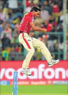  ?? PTI ?? King's XI Punjab Sandeep Sharma celebrates the wicket of Virat Kohli during an IPL match against Royal Challenger­s Bangalore in Bengaluru on Friday.