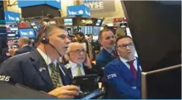  ??  ?? NEW YORK: Traders work on the floor at the closing bell of the Dow Industrial Average at the New York Stock Exchange in New York. —AFP