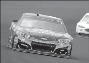  ?? The Associated Press ?? CITIZEN KAHNE: Kasey Kahne drives into turn one during the NASCAR Brickyard 400 auto race last Sunday at Indianapol­is Motor Speedway. Despite the win, Kahne’s future driving the No. 5 Chevrolet beyond this season remains murky.