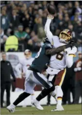  ?? MICHAEL PEREZ — THE ASSOCIATED PRESS ?? Redskins quarterbac­k Mark Sanchez is hit by the Eagles’ Nigel Bradham during Monday’s first half.