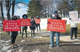  ?? NATHAN DENETTE THE CANADIAN PRESS ?? People protest outside the Tendercare Living Centre in late December. John Doherty, right, is president of the company that owns the long- term- care facility.