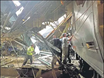  ?? AFP ?? Officers survey a transit train that crashed into a platform of the Hoboken terminal in New Jersey on Thursday.