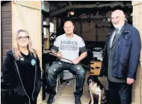  ??  ?? All smiles Nicola Crawford, sales and marketing manager at Gillies and Mackay, Paul Wilkie and his PTSD service dog Irma, and Stuart Wardrop, case worker at SSAFA
him.
With the support of SSAFA, the Armed Forces Charity, Paul secured a grant of £900 to buy a pottery shed for his garden.
He approached Gillies and Mackay who immediatel­y saw the benefit pursuing this hobby would bring him and offered to install a shed that