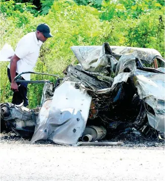  ?? ERROL CROSBY ?? This car burst into fire along Chesterfie­ld Drive in St Andrew last week after being involved in a three-vehlicle crash. Two persons died in the accident.