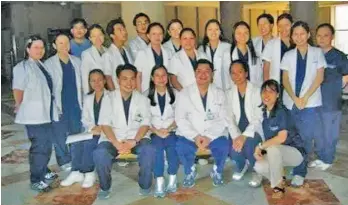  ??  ?? LEARNERS BEFORE. Dr. Hafid Millan (5th from left, standing), Dr. Louie Lopez (6th from left, standing), and Dr. Fredeswind­a Maco (9th from left, standing) as classmates at the Philippine General Hospital in 2005.