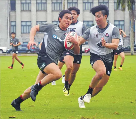  ?? Picture: ELIKI NUKUTABU ?? Atsushi Nishiyama (with the ball) tries to outrun a teammate during the Japan Academy rugby 7s team’s training session at Albert Park in Suva yesterday.